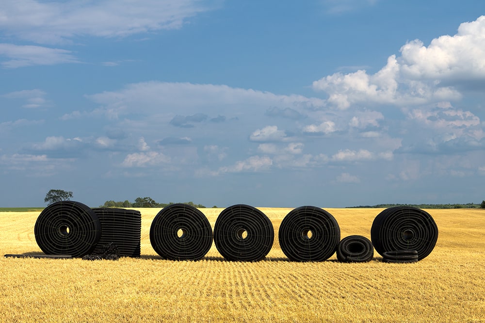 prairie field with black coil tubes in the foreground